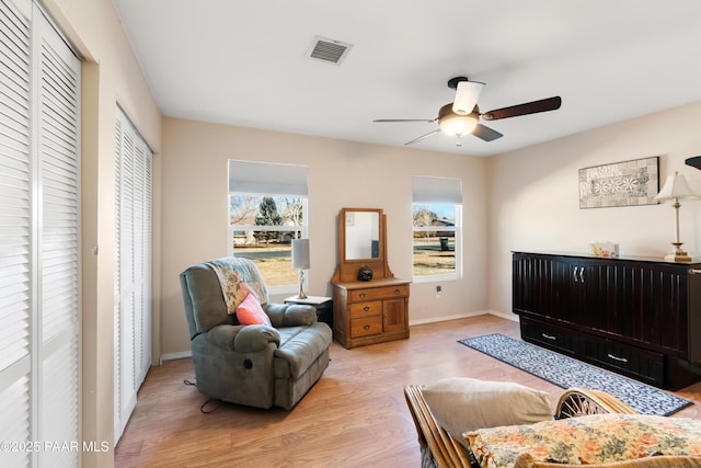 sitting room featuring light wood-type flooring and ceiling fan