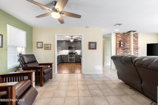 tiled living room featuring ceiling fan