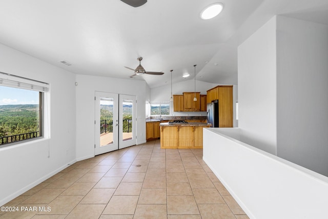 720 E Sky Terrace Dr, Prescott, AZ 86303 - kitchen featuring light tile patterned flooring, ceiling fan, freestanding refrigerator, a kitchen island, and vaulted ceiling