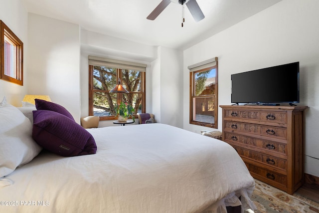 bedroom with a ceiling fan and wood finished floors