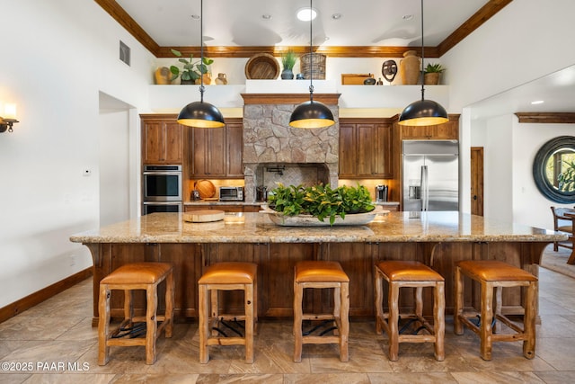 kitchen featuring a spacious island, visible vents, ornamental molding, decorative backsplash, and stainless steel appliances