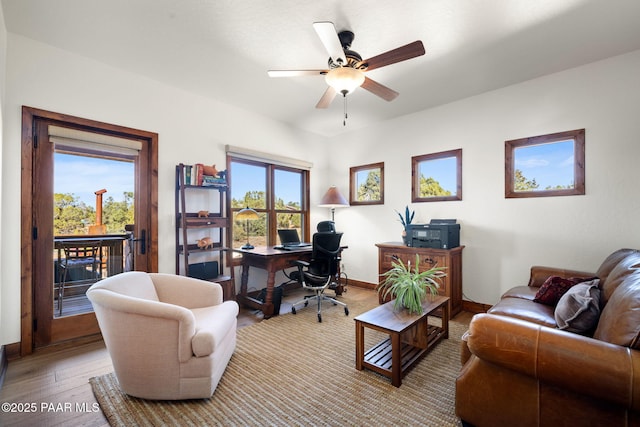 office space featuring ceiling fan, baseboards, and hardwood / wood-style floors