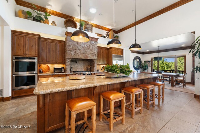 kitchen with tasteful backsplash, crown molding, double oven, a high ceiling, and a sink