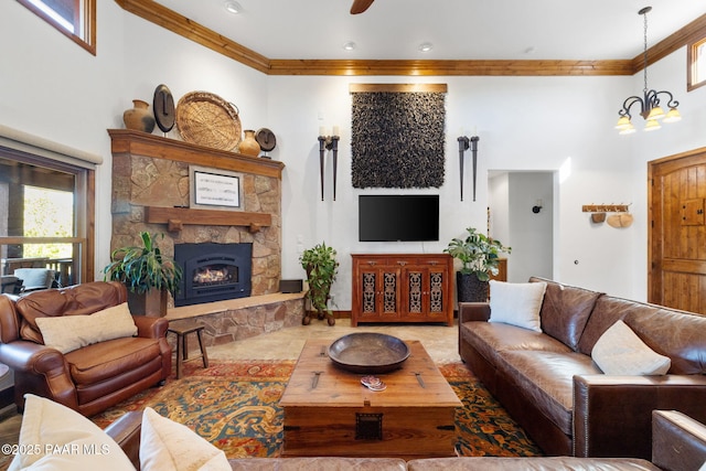 living area with crown molding, a fireplace, and a towering ceiling