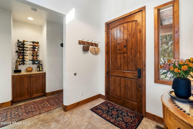 foyer with visible vents and baseboards