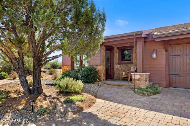 property entrance featuring stone siding