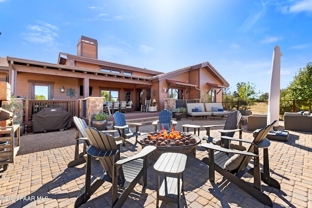 view of patio / terrace featuring an outdoor living space with a fire pit and grilling area