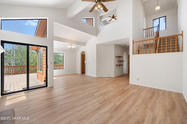 1893 Forest Vw, Prescott, AZ 86305 - unfurnished living room featuring high vaulted ceiling, ceiling fan, wood finished floors, stairs, and beam ceiling