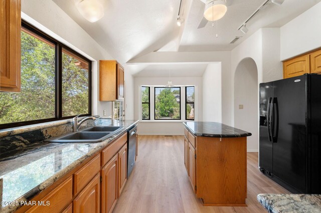 1893 Forest Vw, Prescott, AZ 86305 - kitchen featuring black fridge with ice dispenser, track lighting, stainless steel dishwasher, a kitchen island, and a sink
