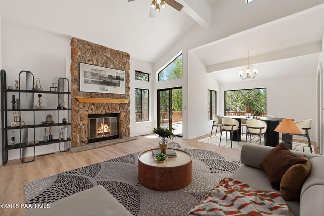 1893 Forest Vw, Prescott, AZ 86305 - living room featuring wood finished floors, beam ceiling, a stone fireplace, ceiling fan, and a chandelier