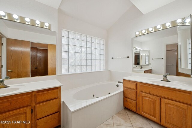 1893 Forest Vw, Prescott, AZ 86305 - full bathroom with two vanities, a jetted tub, vaulted ceiling, and tile patterned floors