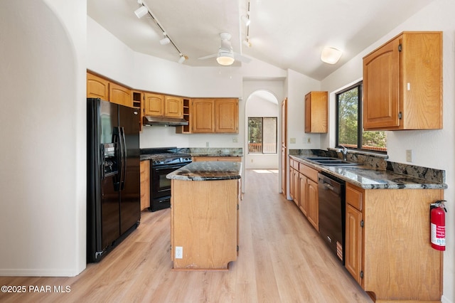 1893 Forest Vw, Prescott, AZ 86305 - kitchen featuring black appliances, under cabinet range hood, a center island, arched walkways, and a sink