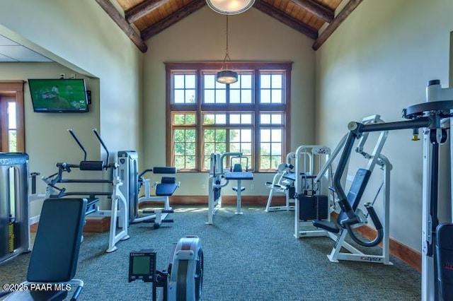 gym featuring lofted ceiling, wooden ceiling, carpet floors, and baseboards