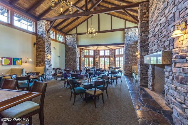 dining room featuring beam ceiling, high vaulted ceiling, a healthy amount of sunlight, and wooden ceiling