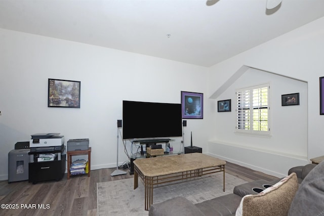 living area featuring baseboards, wood finished floors, and a ceiling fan