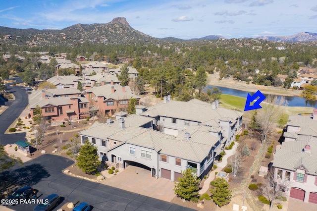 drone / aerial view featuring a residential view and a water and mountain view