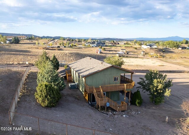 1245 N Windmill Way, Chino Valley, AZ 86323 - view of front of house featuring stairs, a deck with mountain view, central air condition unit, and a rural view