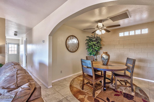 1245 N Windmill Way, Chino Valley, AZ 86323 - dining space with arched walkways, a ceiling fan, light tile patterned floors, and baseboards