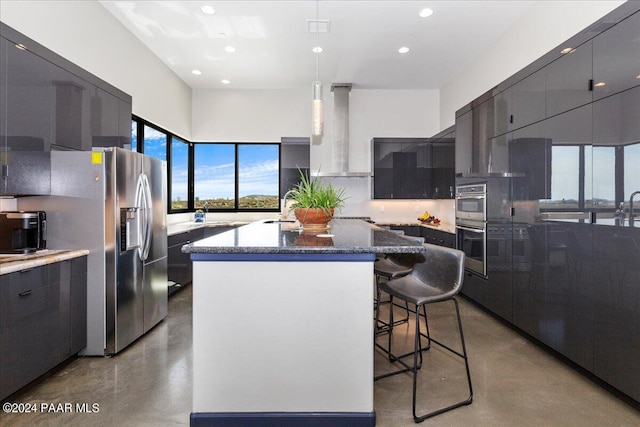 7420 E Reins Ct, Prescott Valley, AZ 86314 - kitchen with finished concrete flooring, a kitchen island, modern cabinets, recessed lighting, and a kitchen bar