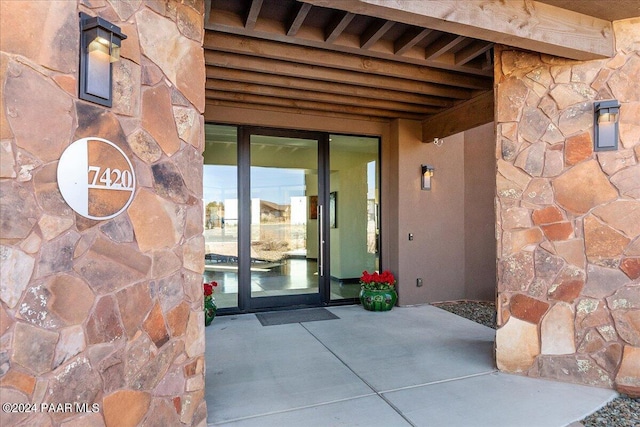 7420 E Reins Ct, Prescott Valley, AZ 86314 - property entrance with stone siding and a patio area