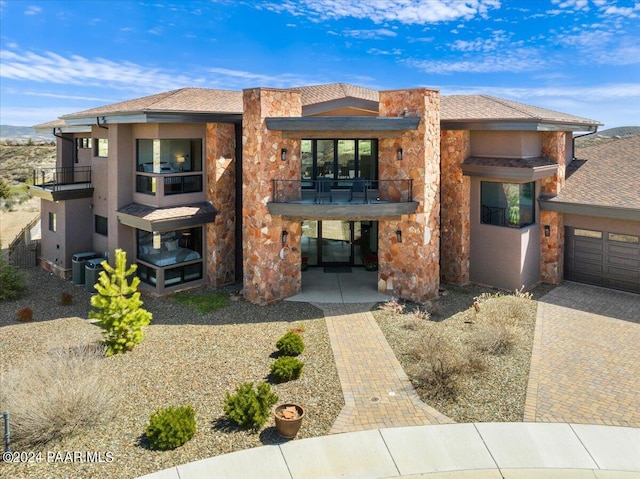 view of front of home with a patio area and a balcony