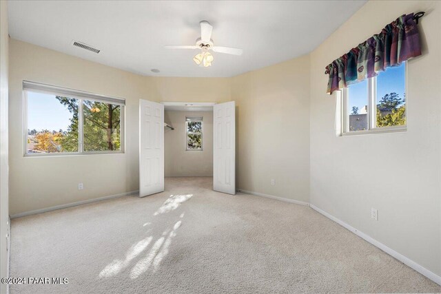 unfurnished bedroom featuring ceiling fan and carpet