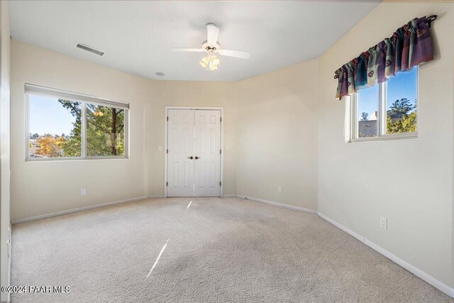 spare room with carpet flooring and ceiling fan