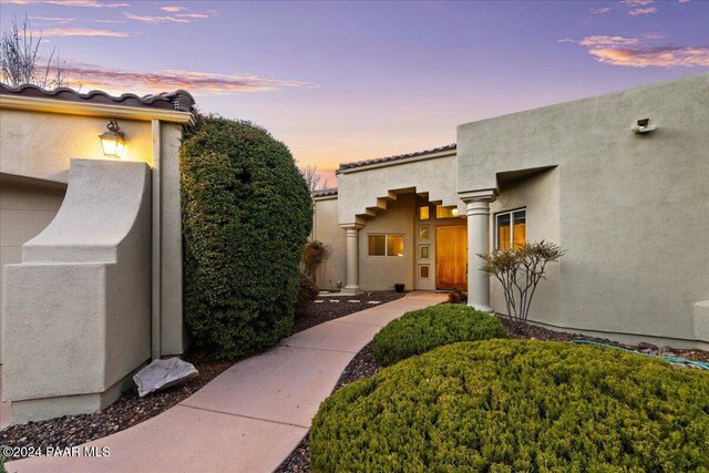 view of exterior entry at dusk