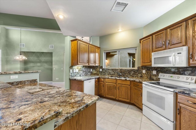 kitchen featuring white appliances, backsplash, sink, hanging light fixtures, and light tile patterned floors