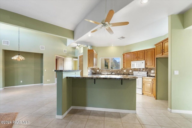 kitchen featuring light tile patterned flooring, white appliances, ceiling fan with notable chandelier, and backsplash