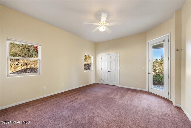 unfurnished bedroom featuring access to exterior, a closet, ceiling fan, and light colored carpet