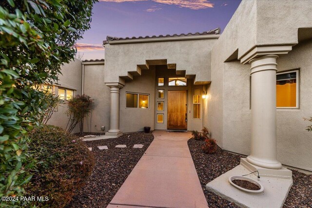 view of exterior entry at dusk