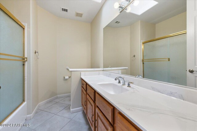 bathroom with shower / bath combination with glass door, tile patterned flooring, and vanity