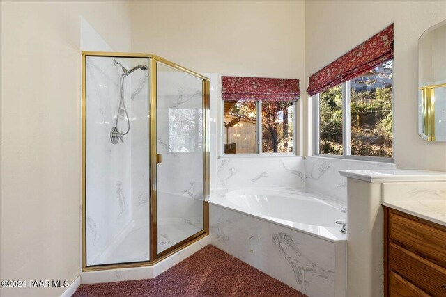 bathroom featuring separate shower and tub and vanity