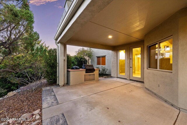 patio terrace at dusk with area for grilling