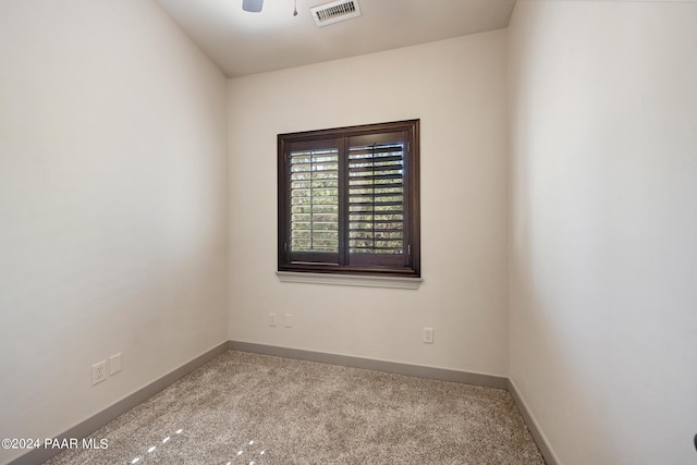 spare room with light colored carpet and ceiling fan