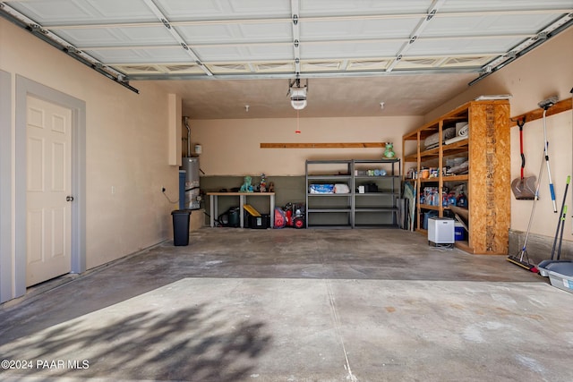 garage with gas water heater and a garage door opener