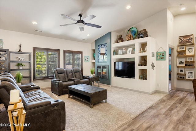 living room featuring hardwood / wood-style floors, vaulted ceiling, and ceiling fan