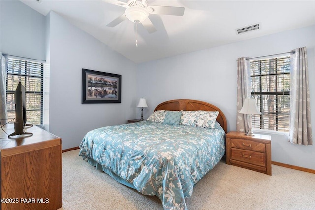 bedroom featuring light carpet, multiple windows, vaulted ceiling, and ceiling fan