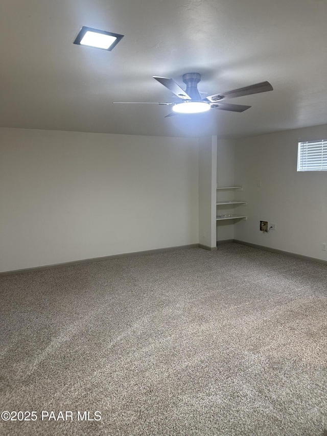 spare room featuring ceiling fan and carpet flooring