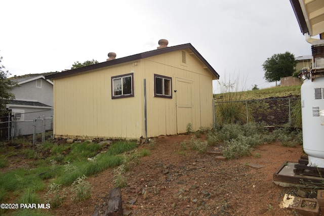 view of side of property featuring a storage unit