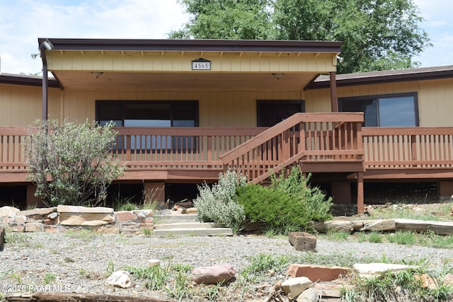 rear view of house with a wooden deck