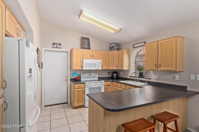 15306 W Eureka Trl, Surprise, AZ 85374 - kitchen with white appliances, a sink, vaulted ceiling, dark countertops, and a peninsula