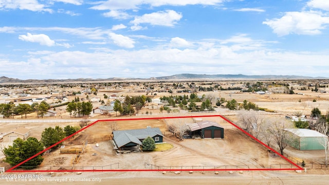 birds eye view of property featuring view of desert and a mountain view