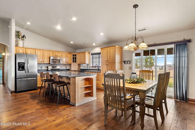 dining area with an inviting chandelier, a healthy amount of sunlight, visible vents, and dark wood-type flooring