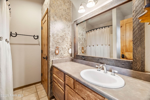 full bathroom featuring tile patterned floors, baseboards, and vanity