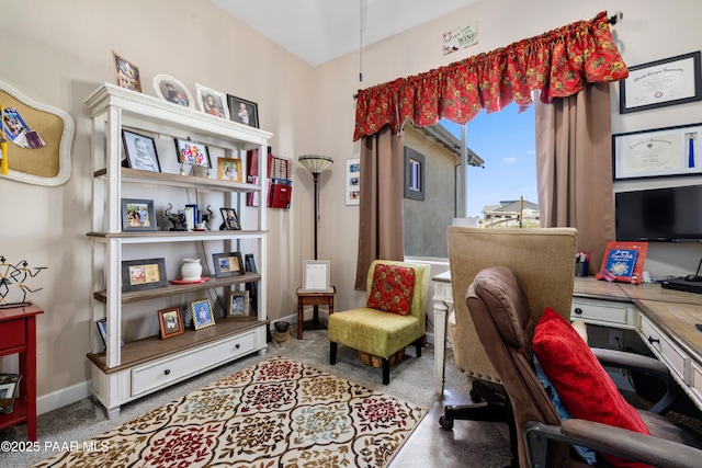 carpeted office space featuring baseboards