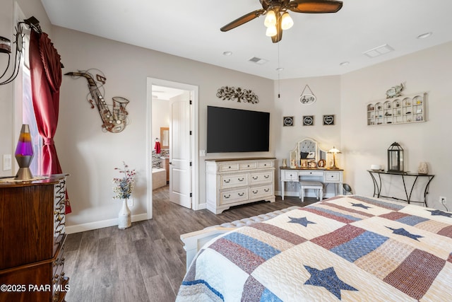 bedroom featuring wood finished floors, visible vents, and baseboards