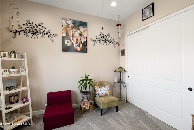 living area featuring carpet floors and baseboards