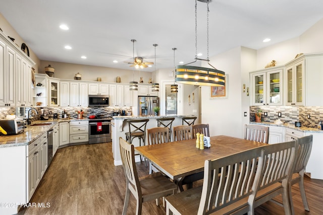 dining room featuring dark wood finished floors and recessed lighting